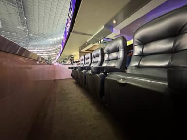 Leather stadium-style seating inside Hall of Fame Suite