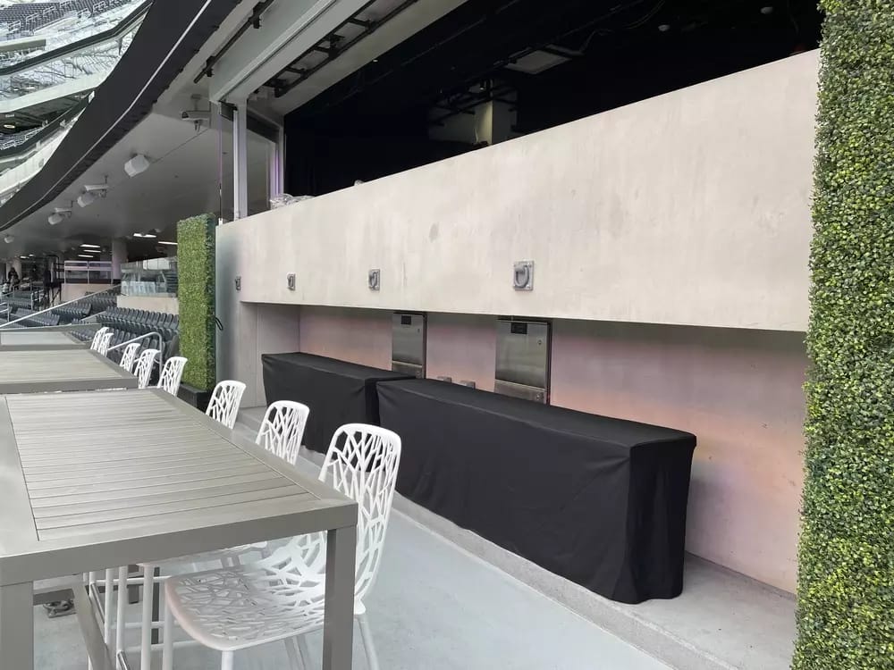 Lower level of the suite, with barstool seating on the patio with a great view of the action. 